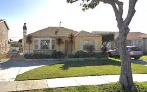 A house with grass on the front lawn