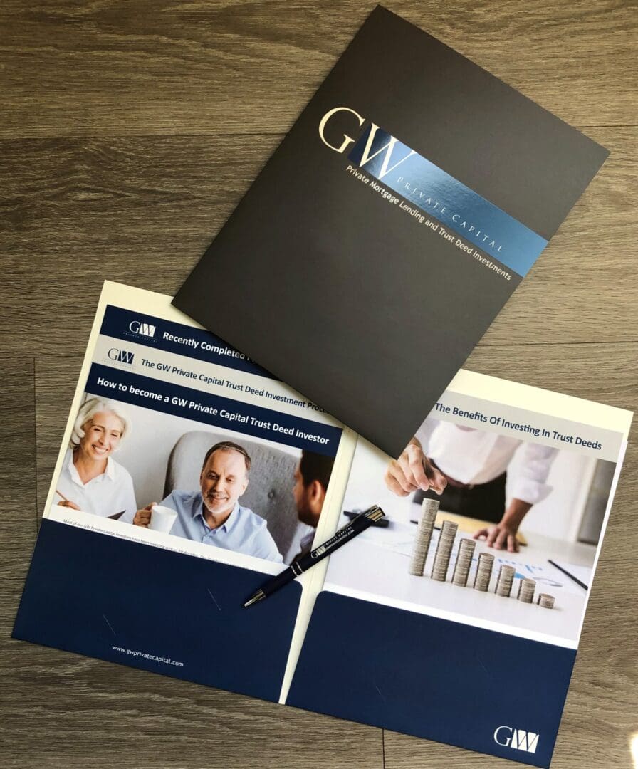 investo package photo A pair of scissors and two folders on top of a table.